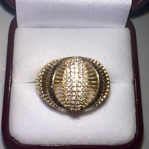Solid gold ring with pave diamonds on sides.